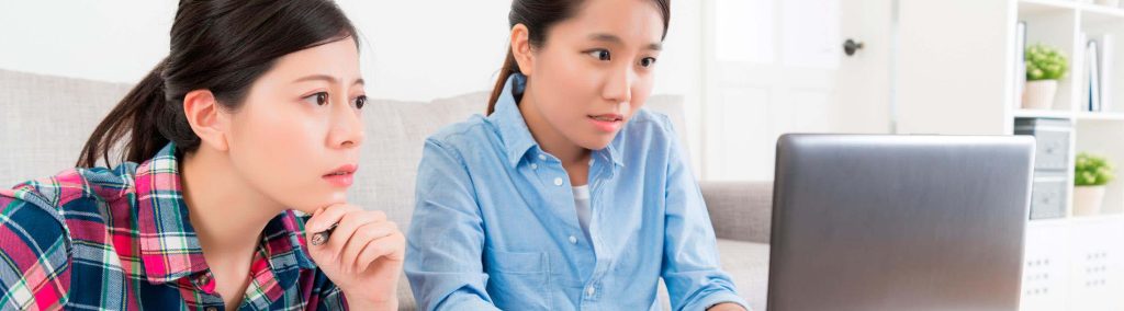 Curious asian woman using computer