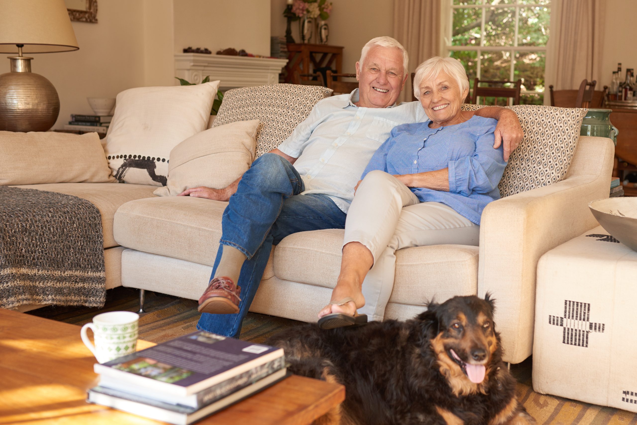 Older couple sitting on a white couch