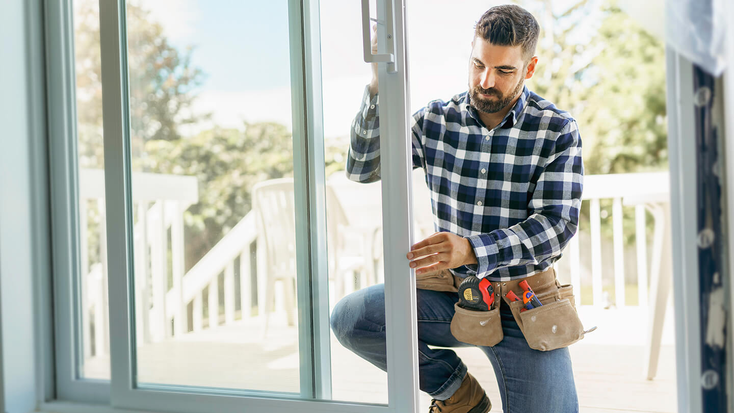 A contractor installing a patio sliding door